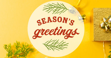 Composition of season&#39;s greetings text over christmas decorations and presents on yellow background. christmas, winter, tradition and celebration concept digitally generated image.の写真素材