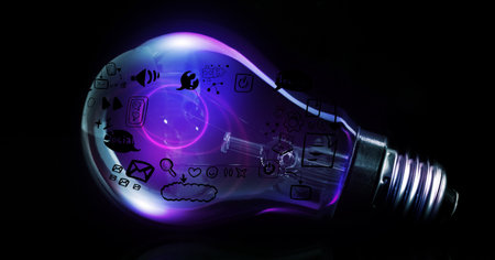 Illustrative image of illuminated light bulb with social networking icons against black background. social networking, communication and connection.の写真素材