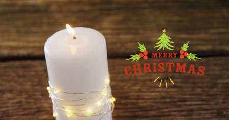 Image of merry christmas text over christmas candles. christmas, tradition and celebration concept digitally generated image.の写真素材