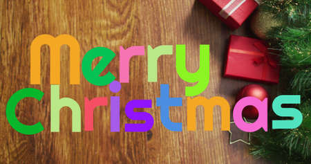 Image of merry christmas text over presents. christmas, winter, tradition and celebration concept digitally generated image.の写真素材