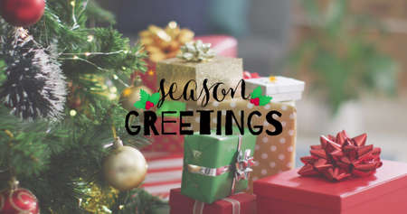Image of season greetings text over christmas gifts. christmas, winter, tradition and celebration...