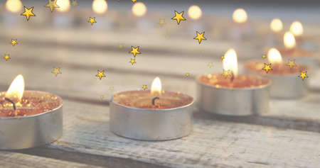 Image of stars falling over merry christmas text on tealights in background. christmas, tradition...