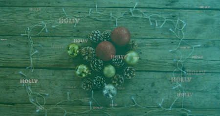 Image of holly text in white, on green over christmas decorations and fairy lights. christmas, tradition and celebration concept digitally generated image.の写真素材