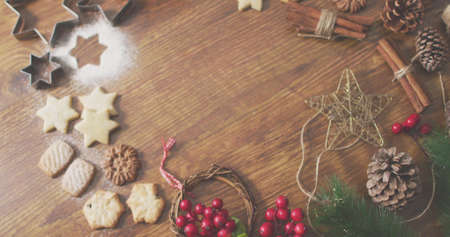 Image of merry christmas text over christmas decorations. christmas, winter, tradition and celebration concept digitally generated image.の写真素材