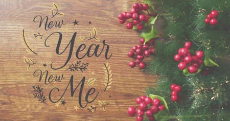 Image of new year new me text over christmas wreath. christmas, winter, tradition and celebration concept digitally generated image.の写真素材