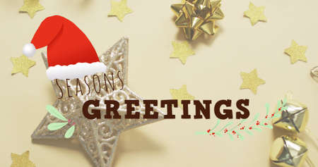 Image of seasons greetings text over christmas decorations. christmas, winter, tradition and celebration concept digitally generated image.の写真素材