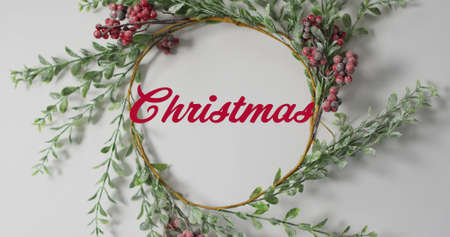 Image of christmas text over wreath. christmas, winter, tradition and celebration concept digitally generated image.の写真素材