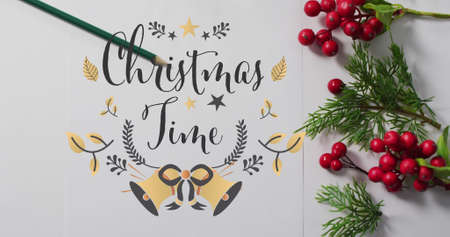 Image of christmas time text over christmas decorations. christmas, winter, tradition and celebration concept digitally generated image.の写真素材