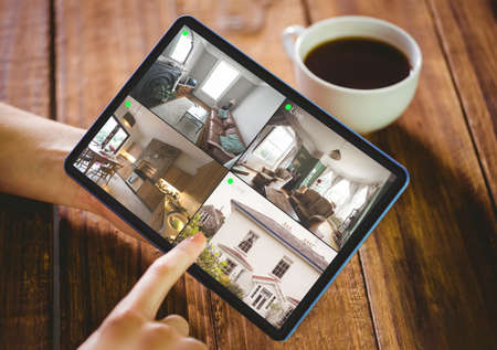 Woman using her tablet pc on wooden tableの写真素材