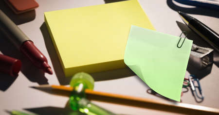 Image of memo note with copy space over stationery items on desk. national clean your desk day concept digitally generated image.の写真素材