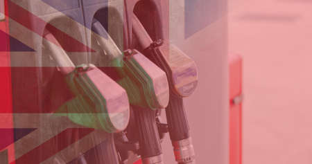 Double exposure of fuel pumps at gas station with union jack flag. digital composite, identity and petrol.の写真素材