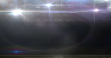 Lens flare at illuminated american football stadium at night. bright lights glowing at sports field.の写真素材