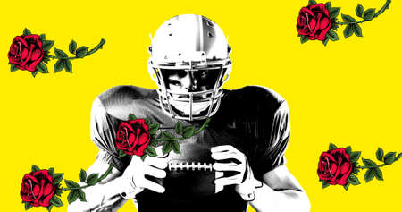 Portrait of confident male american footballer holding ball by roses against yellow background....