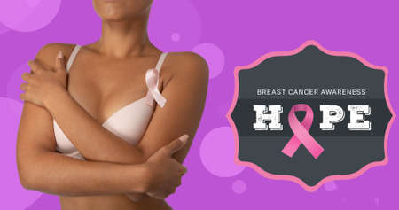 Composite image of woman in bra by hope text and breast cancer ribbon against purple background. breast cancer awareness campaign and vector.の写真素材