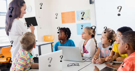 Digital composite of question marks over teacher showing tablet pc to students in classroom. education and knowledge.の写真素材