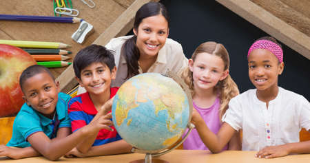 Portrait of smiling teacher and students learning about planet earth on globe. digital composite of education, knowledge and mentorship.の写真素材