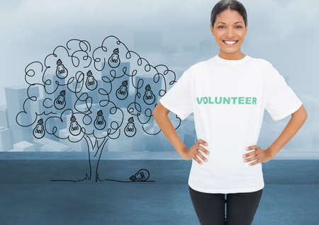 African american female volunteer smiling against over bulbs hanging on a tree against cityscape. volunteering conceptの写真素材