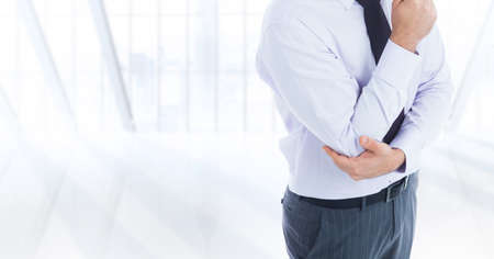 Composite image of mid section of a businessman against office interior in background. business and office conceptの写真素材