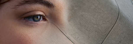 Composite image of close up of a female eye and grunge effect textured background. biometric scanning technology conceptの写真素材