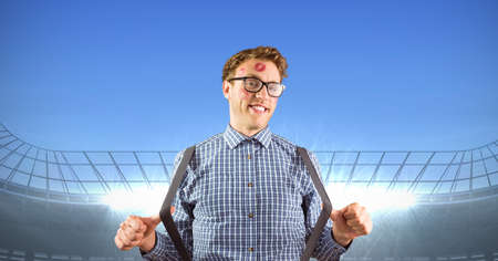 Composite image of man with lipstick kiss stains on his face against sports stadium with copy space. sports competition and tournament conceptの写真素材