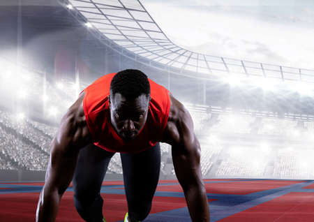 African american male athlete on starting position at running track against sports stadium. sports...
