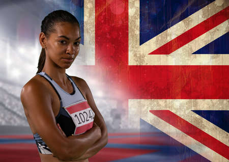 Portrait of african american female athlete against great britain flag and sports stadium. patriotism and sports conceptの写真素材