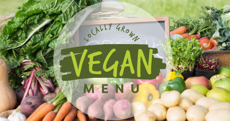 Close-up of locally grown vegan menu symbol over fresh vegetables. digital composite of healthy food...