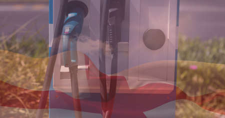 Double exposure of english flag over electric vehicle charging plugs at station. environmental conservation, patriotism and identity, unaltered.の写真素材