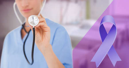 Blue cancer awareness ribbon and midsection of caucasian female young doctor holding stethoscope. digital composite, copy space, world cancer day, alertness, awareness and hospital concept.の写真素材