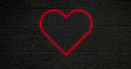Image of flickering neon social media heart icon on brick wall. social media and communication concept digitally generated image.の写真素材