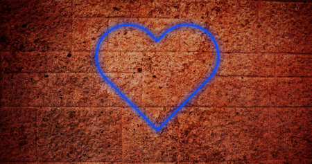 Image of flickering neon heart icon on brick wall. social media and communication concept digitally generated image.の写真素材