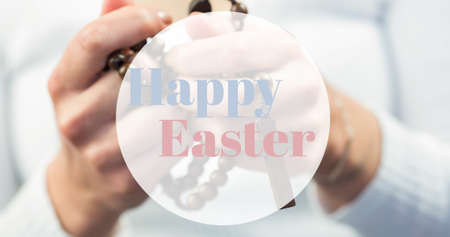 Happy easter symbol text over person holding prayer beads. digital composite, festive, symbol and...