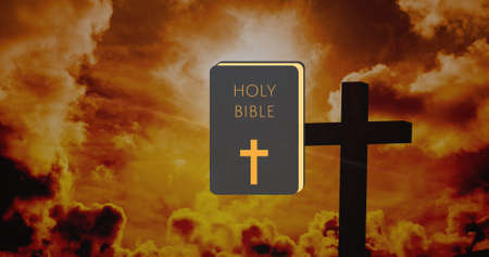 Image of crucifix over holy bible on landscape. good friday celebration concept digitally generated...