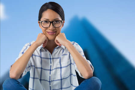 Composite image of portrait of african american woman smiling against tall buildings in background....