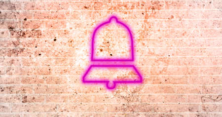 Image of glowing neon bell icon on brick wall. social media and communication concept digitally generated image.の写真素材