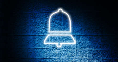 Image of glowing neon bell icon on brick wall. social media and communication concept digitally generated image.の写真素材