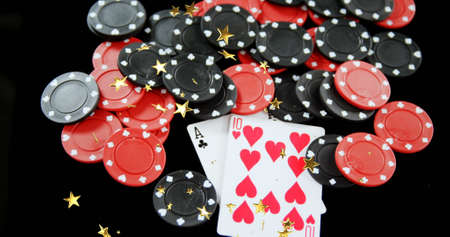 Image of moving stars over poker chips and cards on black background. hazard and casino concept...