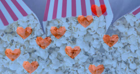 Image of heart icons over boxes of popcorn. popcorn day and celebration concept digitally generated...