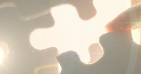 Image of hand of caucasian man adding puzzle on place. national puzzle day and brain activity concept digitally generated image.の写真素材