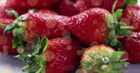 Image of spots over fresh strawberries. national vegetarian week and celebration concept digitally generated image.の写真素材