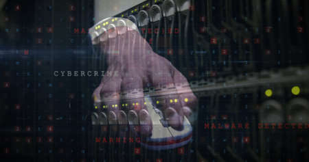 Image of cyber attack warning over hand of caucasian man in server room. global internet security,...