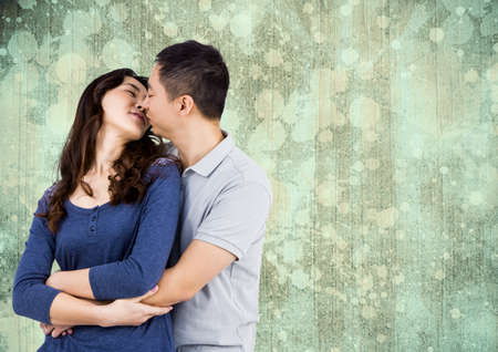 Asian young couple embracing each others against copy space on textured wooden background. love and relationship conceptの写真素材