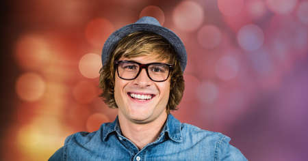 Portrait of caucasian man smiling against spots of light in background. people and emotions conceptの写真素材