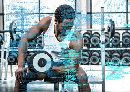 Composite image of data processing against african american fit man working out at the gym. sports fitness and technology conceptの写真素材