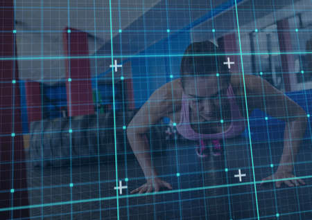 Grid network against caucasian fit woman performing push up exercise at the gym. sports, fitness and technology conceptの写真素材