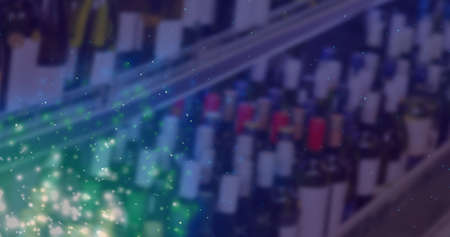 Image of lights over blurred alcohol shop in blue. wine business, tasting and celebration concept digitally generated image.の写真素材