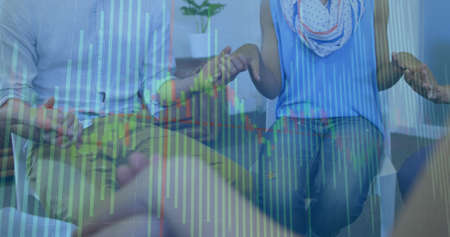 Image of financial data processing over diverse people holding hands. global finance, business and...