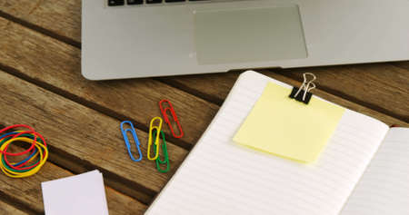 Image of keep your desk clean text on yellow memo note on desk with laptop, coffee and notebook. office workspace concept digitally generated image.の写真素材