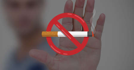 Digital composite image of no smoking symbol over caucasian man&#39;s palm. creative, awareness and healthy lifestyle concept.の写真素材