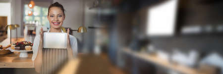Blurred effect with copy space against caucasian waitress with digital tablet at a restaurant. restaurant business conceptの写真素材